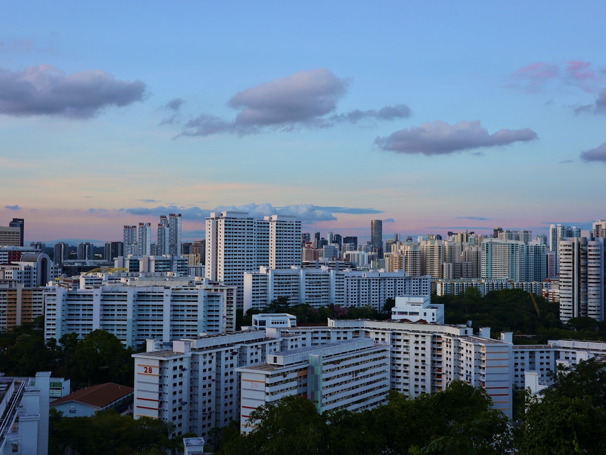 Punggol Waterway at dusk, boardwalk and HDB blocks with the sky going gold to grey